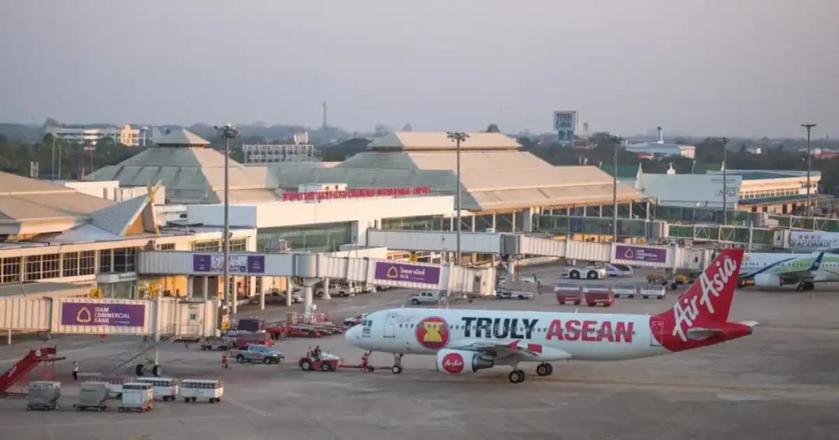 Traveler checking phone at Thailand airport immigration