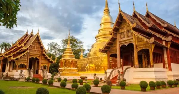 Chiang Mai temple at sunset with tourists visiting Thailand