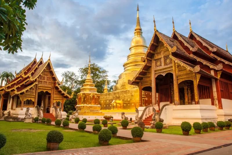 Chiang Mai temple at sunset with tourists visiting Thailand