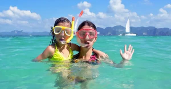 Family with children traveling in Thailand temple