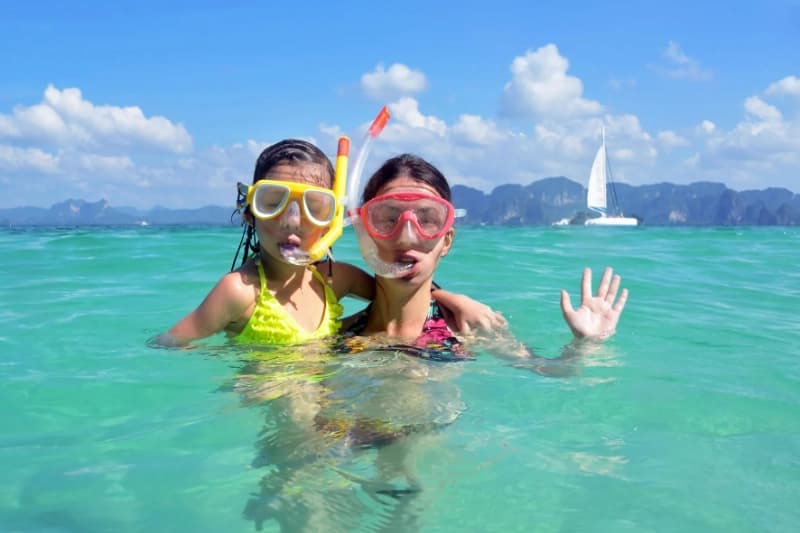 Family with children traveling in Thailand temple